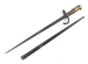 A World War II bayonet, with wooden and brass handle, steel blade, serial number 9562, 65cm long.