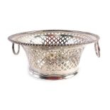 An Edward VII silver sugar basket, with a circular reeded border, and pierced bow basket design, wit