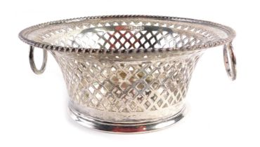 An Edward VII silver sugar basket, with a circular reeded border, and pierced bow basket design, wit