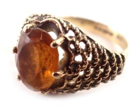 A 9ct gold dress ring, with an oval citrine in a six claw setting, with rope twist layered borders,