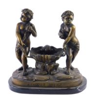 After Carrier Bellose. A bronzed metal sculpture of two figures beside a clam shell, on a shaped mar