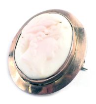 A 20thC shell cameo brooch, the oval cameo depicting maiden with flowing hair, in a rub over rose go