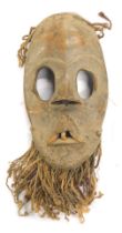 A Dan 'Gunye ge' running mask with original teeth, Cote D'Ivoire, 30cm high.