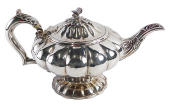 A Victorian silver teapot, with a fluted and moulded body, with an acanthus leaf spout, and floral c