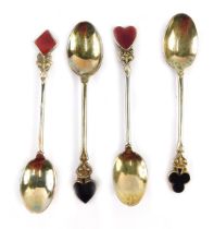 A cased set of four George V silver novelty teaspoons, each top decorated in enamel with a playing c