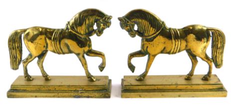 A pair of 19thC brass hearth ornaments, modelled in the form of horses, each on a rectangular base,