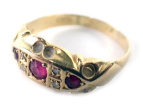 An 18ct gold ruby and diamond gypsy ring, the boat shaped ring head set with three round brilliant c