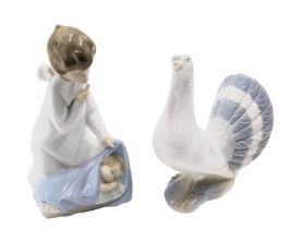 A Lladro figure of a seated mother and child, 17cm high, and a Spanish porcelain figure of a dove,