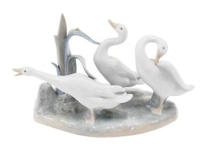 A Lladro figure group, of three geese in reeds, blue stamp to underside, 15cm high.