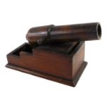 A late 19th/early 20thC oak novelty inkwell in the form of a cannon, the hinged lid enclosing a glas