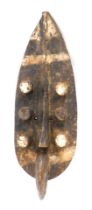 A Grebo (Krou) Maou six eyed warrior shield mask, Liberia, 56cm high.