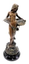 An Austrian depose art nouveau figure, of a semi clad female with lily pad, on a rocky base, with eb