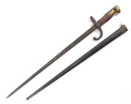 A World War II bayonet, with wooden and brass handle, steel blade, serial number 33409, bearing the