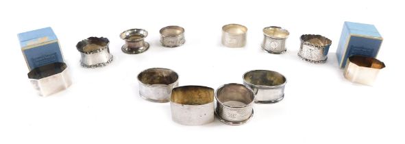 A collection of Edward VII and later silver napkin rings, of varying design and engravings, and a pa