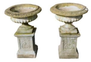 A pair of reconstituted stone urns, the acanthus leaf moulded tops, on square art nouveau plinths, 8