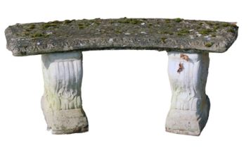 A reconstituted stone garden bench, scroll and flower supports, on a curved seat, 41cm high, 96cm wi