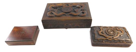 An Eastern hardwood cigarette or cigar box, carved with dragons surrounding a central monogram S.A?,