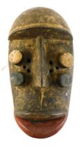 A Grebo (Krou) Maou four eyed warrior mask with kaolin pigments, Liberia, 30cm high.
