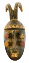 A Grebo (Krou) Maou six eyed warrior mask with antelope horns, Liberia, 38cm high.