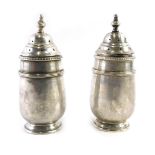 A pair of George V Walker and Hall silver pepperettes, each with a pierced top, Birmingham 1920, 2.8