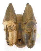 A Baule Old 'Janus' two faced portrait mask (Mblo), Cote D'Ivoire, 39cm high.