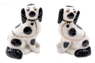 A pair of Staffordshire style comforter spaniels, 21cm high. (2)