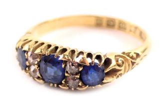 An 18ct gold sapphire and diamond gypsy ring, set with three oval sapphires, each in claw setting an