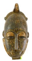 A Baule Mblo spiritual portrait mask, Cote D'Ivoire, 33cm high.