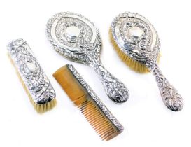 A George V silver four piece dressing table set, comprising hand brush, brush, mirror and comb, each