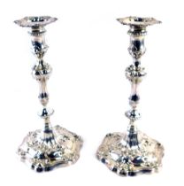 A pair of George III silver candlesticks, each with shell capped hexagonal scrolling base, on a reed