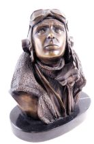 A bronzed Aviation figure, on an oval black marble base, depicting aeroplane pilot, 21cm high, stamp