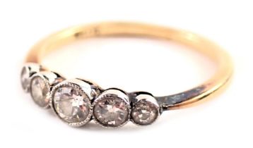 A five stone diamond dress ring, the diamonds in rub over platinum setting of graduated design, the