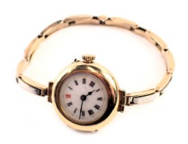 An 18ct gold cased wristwatch, the circular watch head with white enamel Roman numeric dial, blue ha