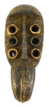 A Grebo (Krou) Maou six eyed maou warrior mask with fixed beak, Liberia, 45cm high.