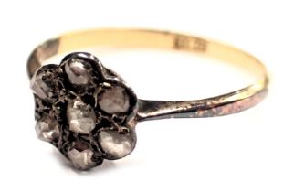 A diamond cluster ring, the floral cluster set with seven old cut diamonds, in a raised basket claw