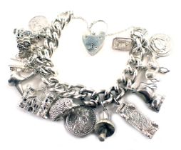 A white metal charm bracelet, with heavy curb link bracelet, safety chain and heart shaped padlock a