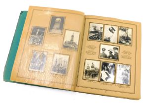 An album containing Third Reich cigarette cards, varying subject matters, to include military proces
