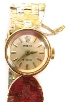 A 9ct gold tricolour Rolex ladies wristwatch, the small silvered dial 1cm diameter, with shaped five