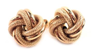 A pair of 9ct gold knot earrings, with crossover hammered and plain design links, on single pin back