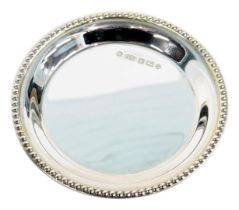 A Queen Elizabeth II silver pin dish, with a beaded border, hallmark to commemorate The Millennium,