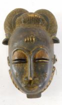 A Baule Mblo spiritual portrait mask with elaborate coiffure, Cote D'Ivoire, 32cm high.