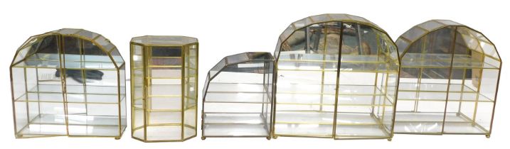 Five glass and gilded sectional display cases.