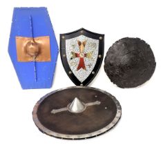 A collection of replica armour, to include a Tudor shield, and two other shields and a display.