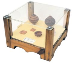 A collection of Indus Valley style pots, to include vases, tablets, seals, etc., in perspex wooden c