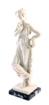 A resin figure of a Greek Goddess, white finish detail stamped PAT, on a square black marble base, 4