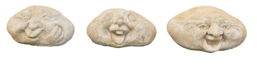 Three reconstituted stone happy stone faces, 19cm wide, and two 15cm wide. (3)