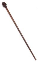 A late 18th/early 19thC walnut and oak walking stick, the handle carved with a head of a gentleman w