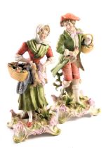 A pair of 19thC Dresden Continental figures, of lady and gentleman carrying flowers and dead wild fo