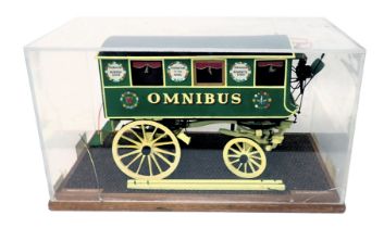A scale model of a horse drawn omnibus coach, in black, green and yellow livery, 1cm:12cm, in perspe