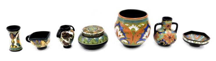 Dutch ceramics, to include two handle vases, pin dishes, vase, jar and cover, stem vase, each on a b